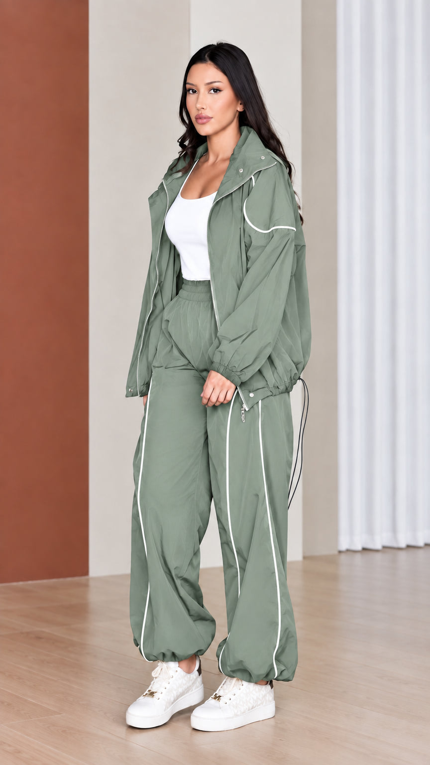 Full-length view of woman wearing sage green 2-piece tracksuit set