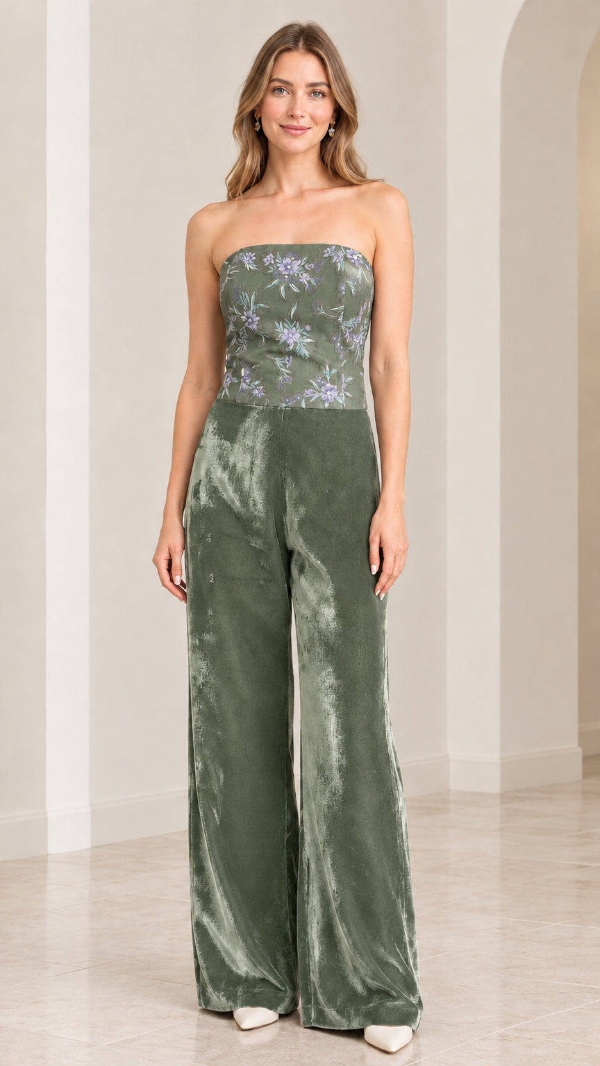 Front view of woman wearing strapless sage green floral velvet wide leg jumpsuit