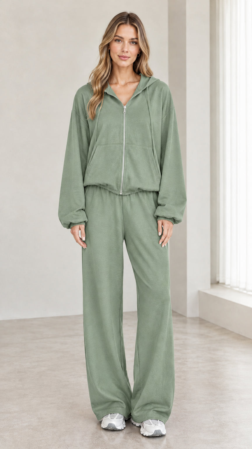 Woman wearing sage green 2-piece zip-up hoodie and wide-leg pants tracksuit set