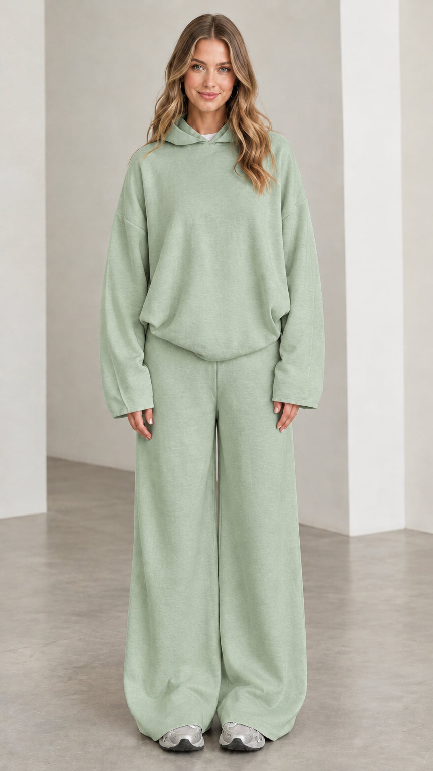 Front view of woman wearing Sage Green relaxed hoodie and wide leg pants set
