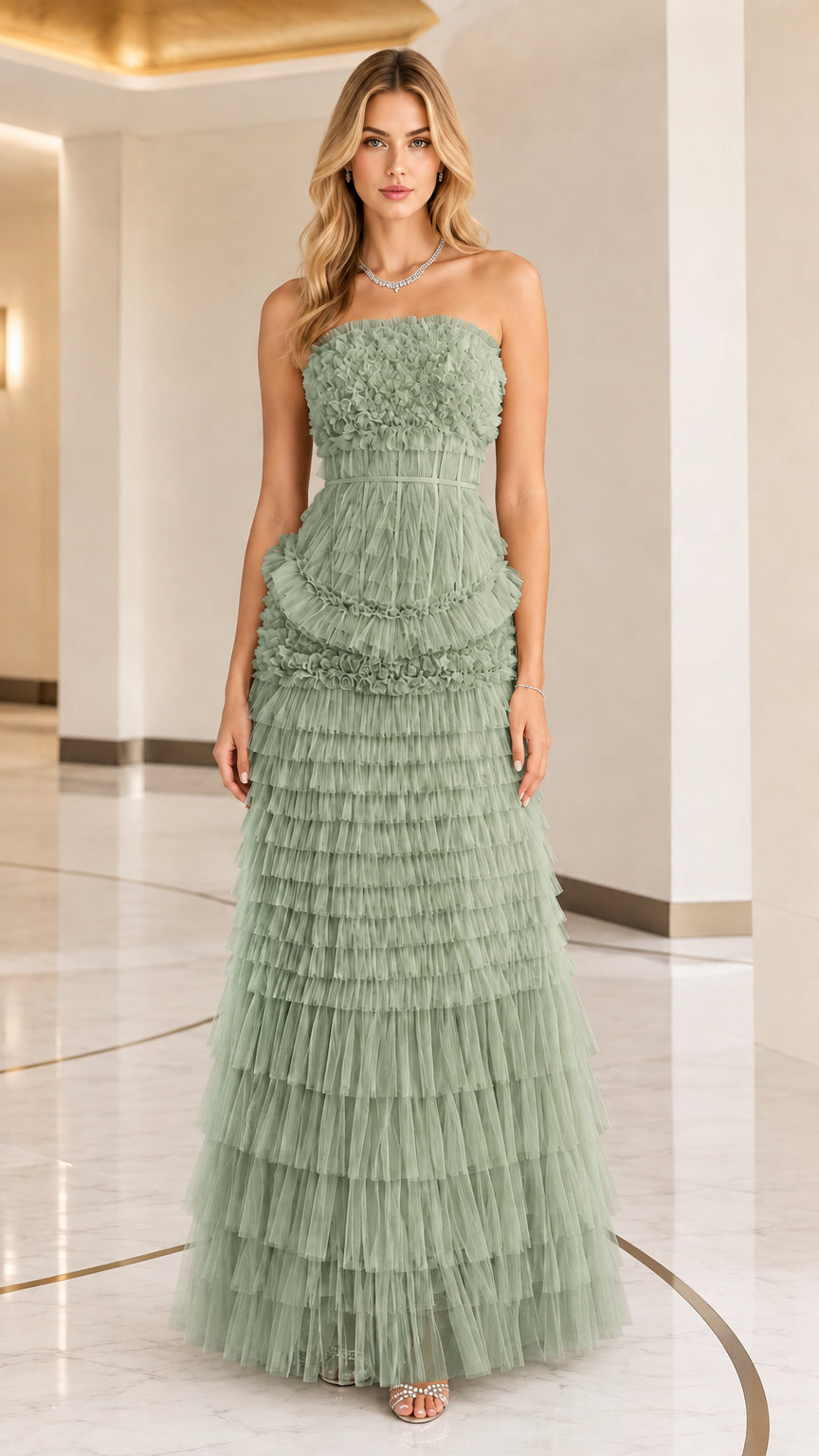 Front full view of woman wearing strapless sage green tiered ruffle tulle evening gown