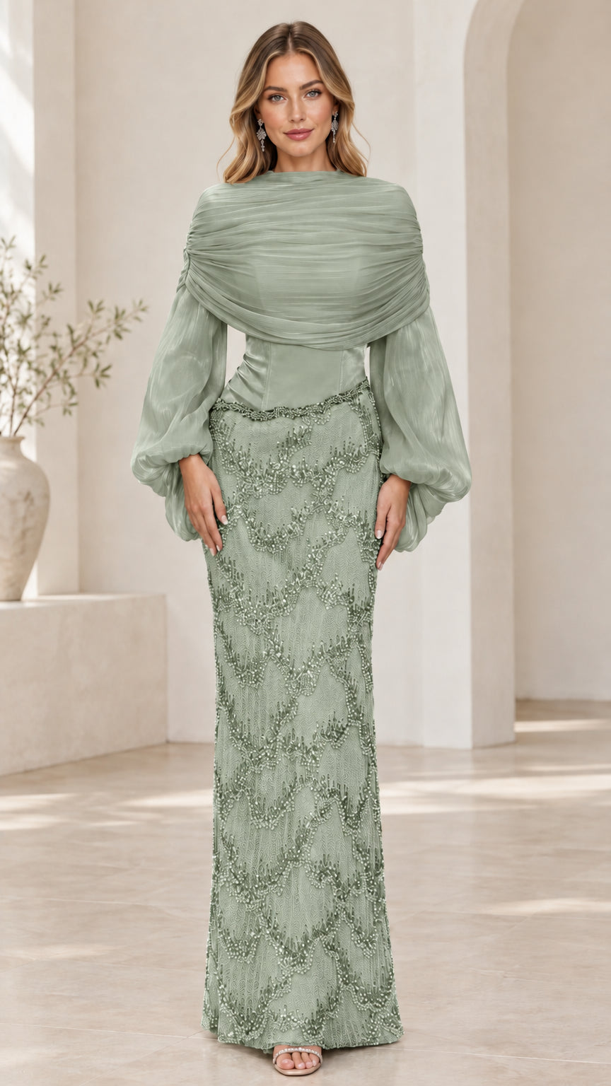 Front view of model wearing sage green draped bishop sleeve beaded gown