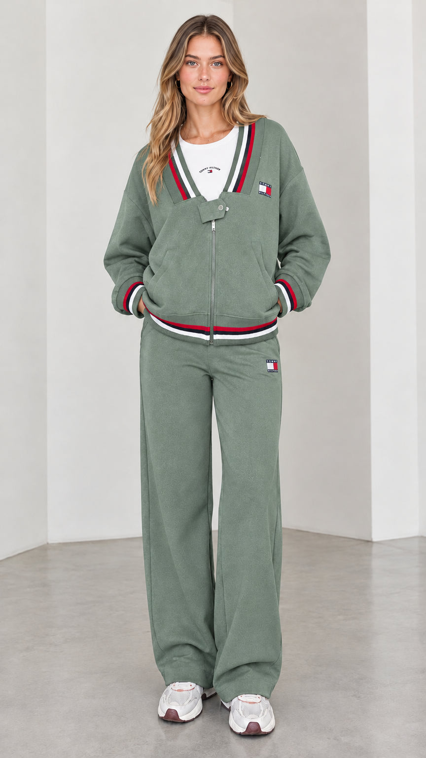 Front view of model wearing sage green varsity striped tracksuit set