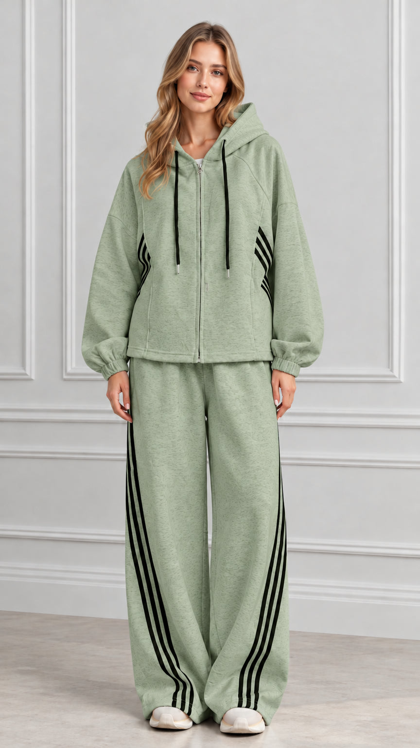 Front view of woman wearing Sage Green zip-up hoodie and wide-leg striped track set