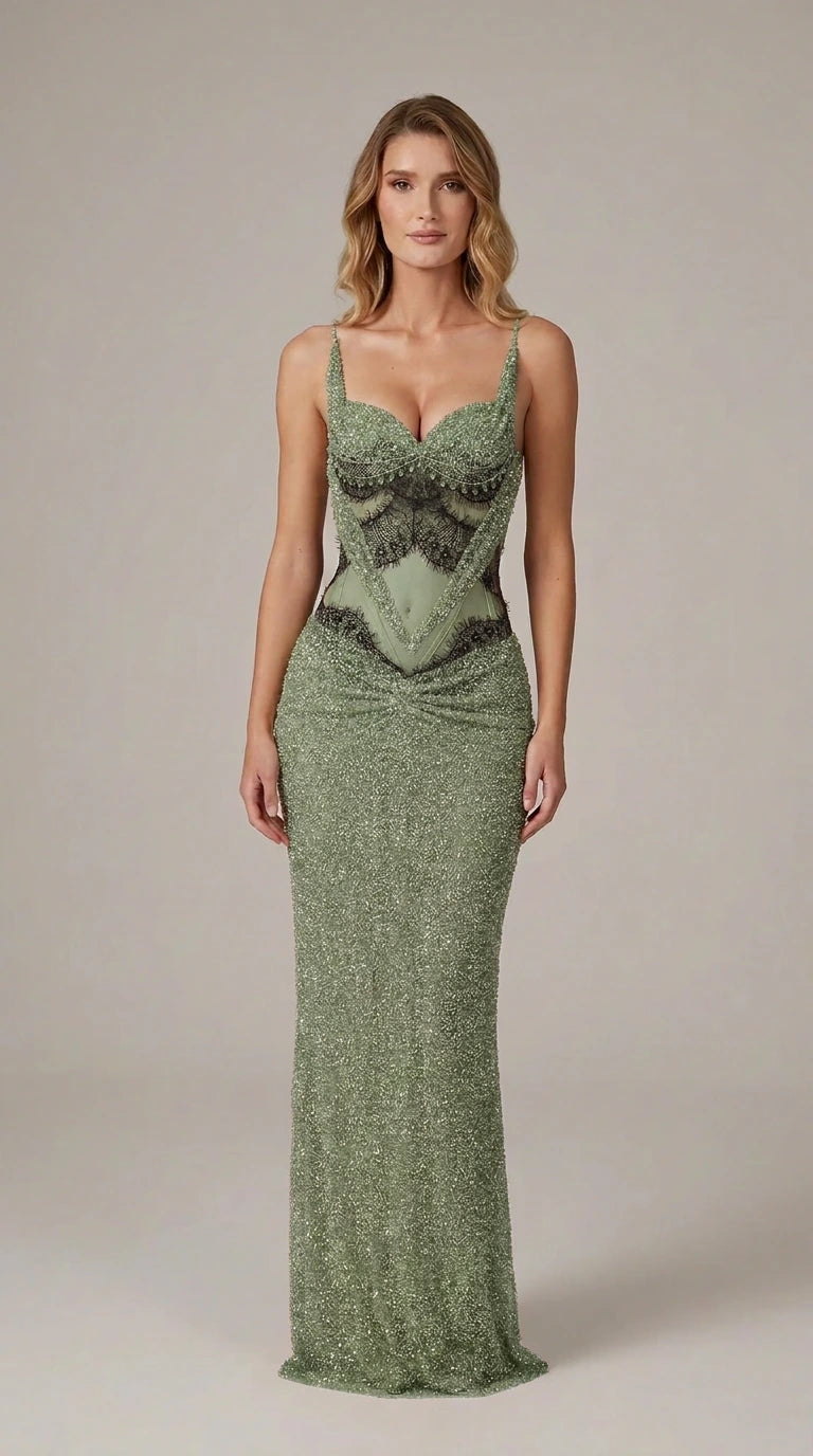 Model wearing sage green beaded evening gown with sheer corset details
