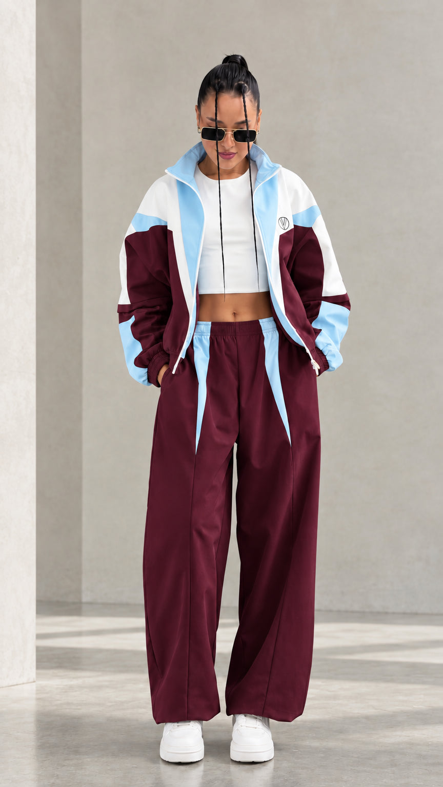 Model wearing Burgundy colorblock tracksuit set with light blue and white accents