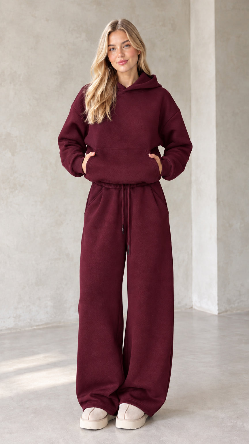 Front view of woman wearing burgundy oversized hoodie and wide leg lounge set
