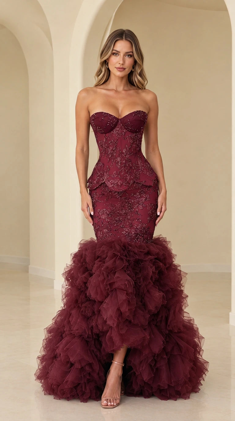 Model wearing burgundy strapless beaded lace corset mermaid gown