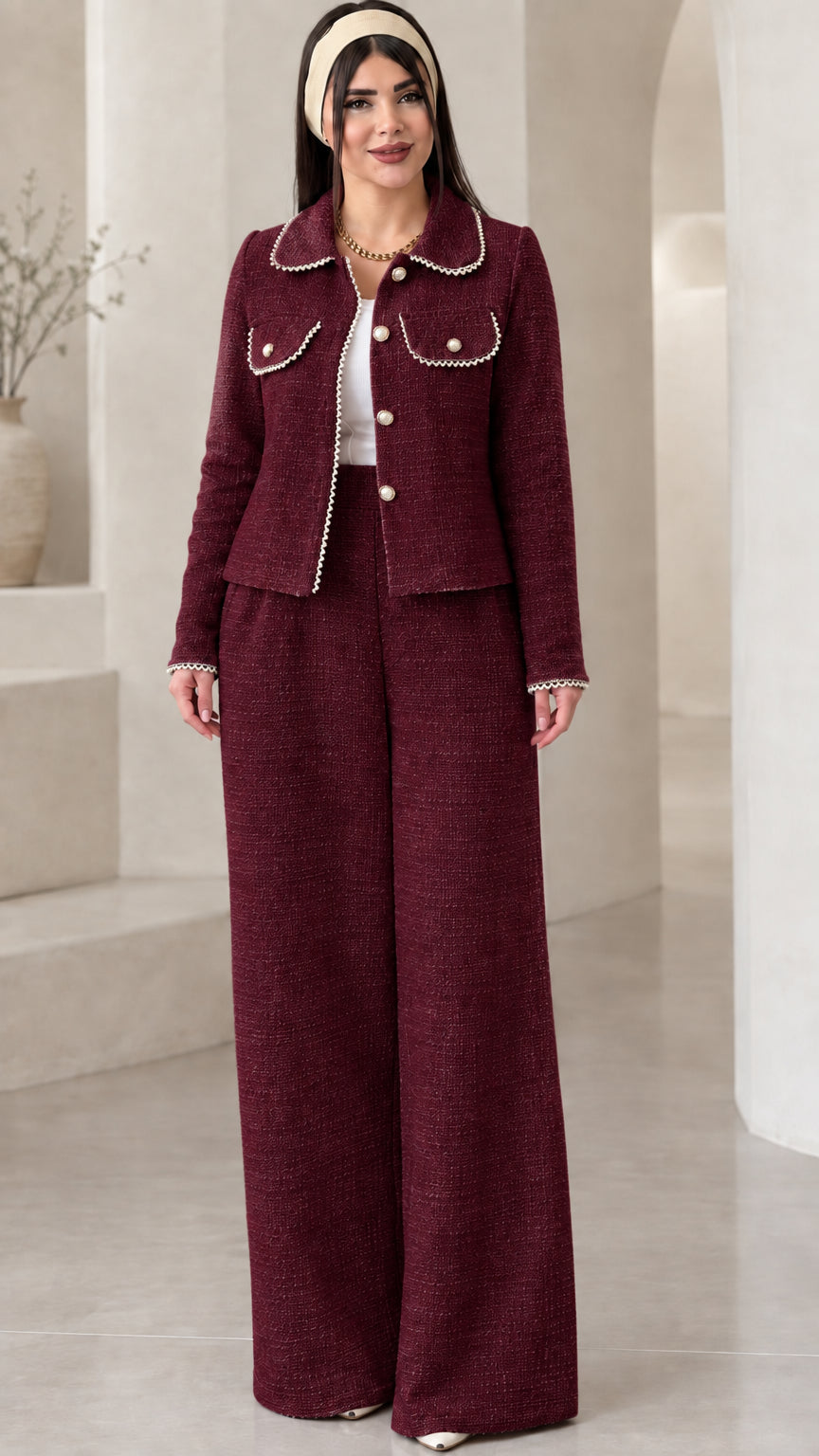 Front view of model wearing the burgundy red pearl-embellished tweed two-piece suit set