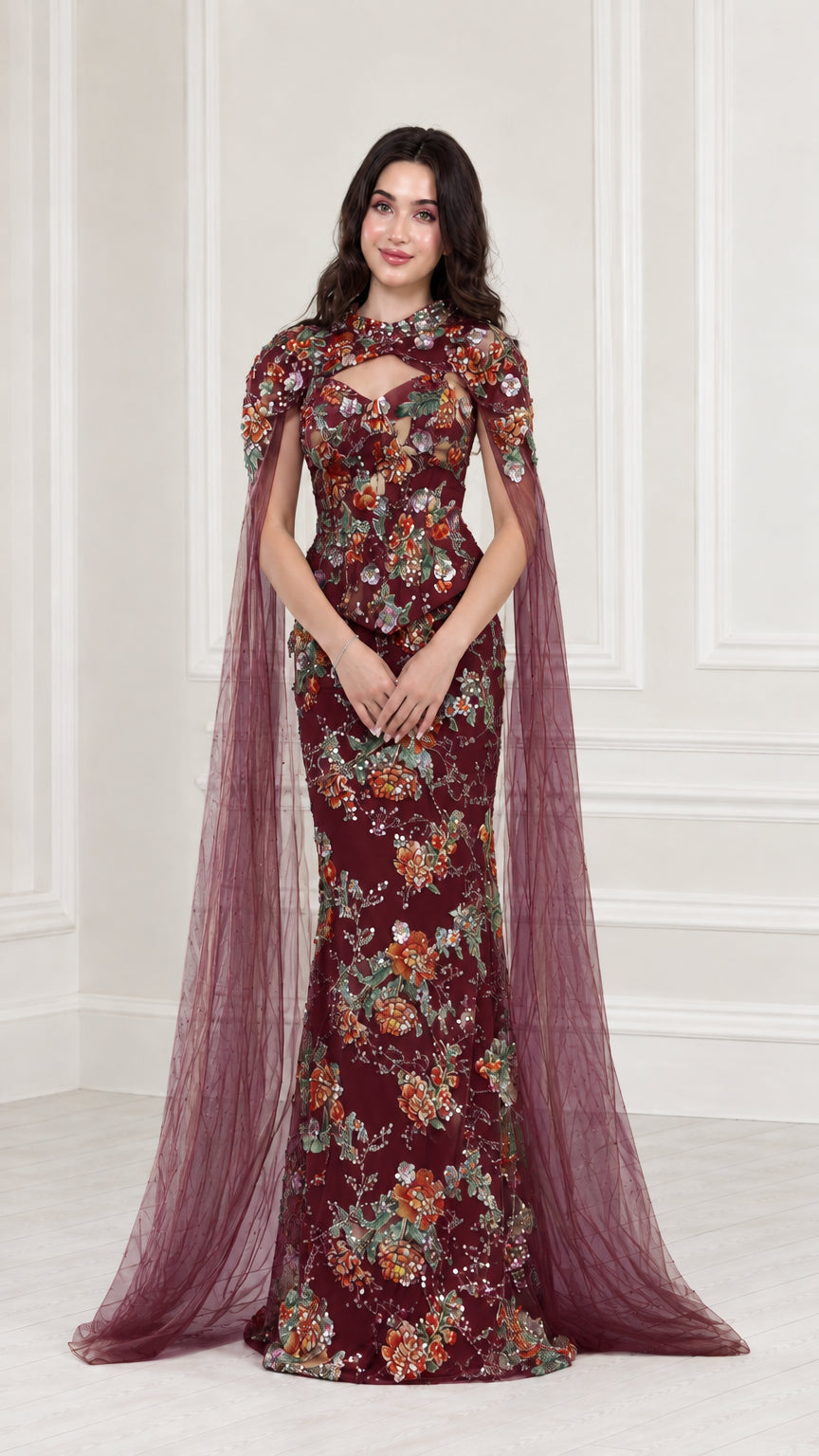 Front view of Burgundy floral embroidered evening gown with sheer wine red cape