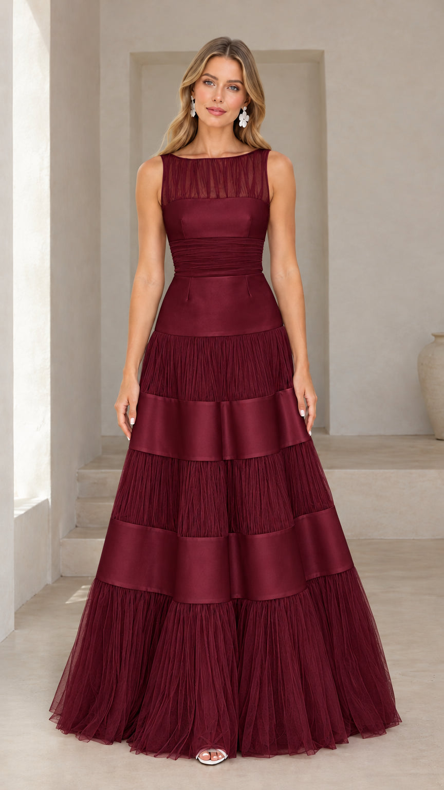 Front view of model wearing burgundy red tiered tulle and satin evening gown