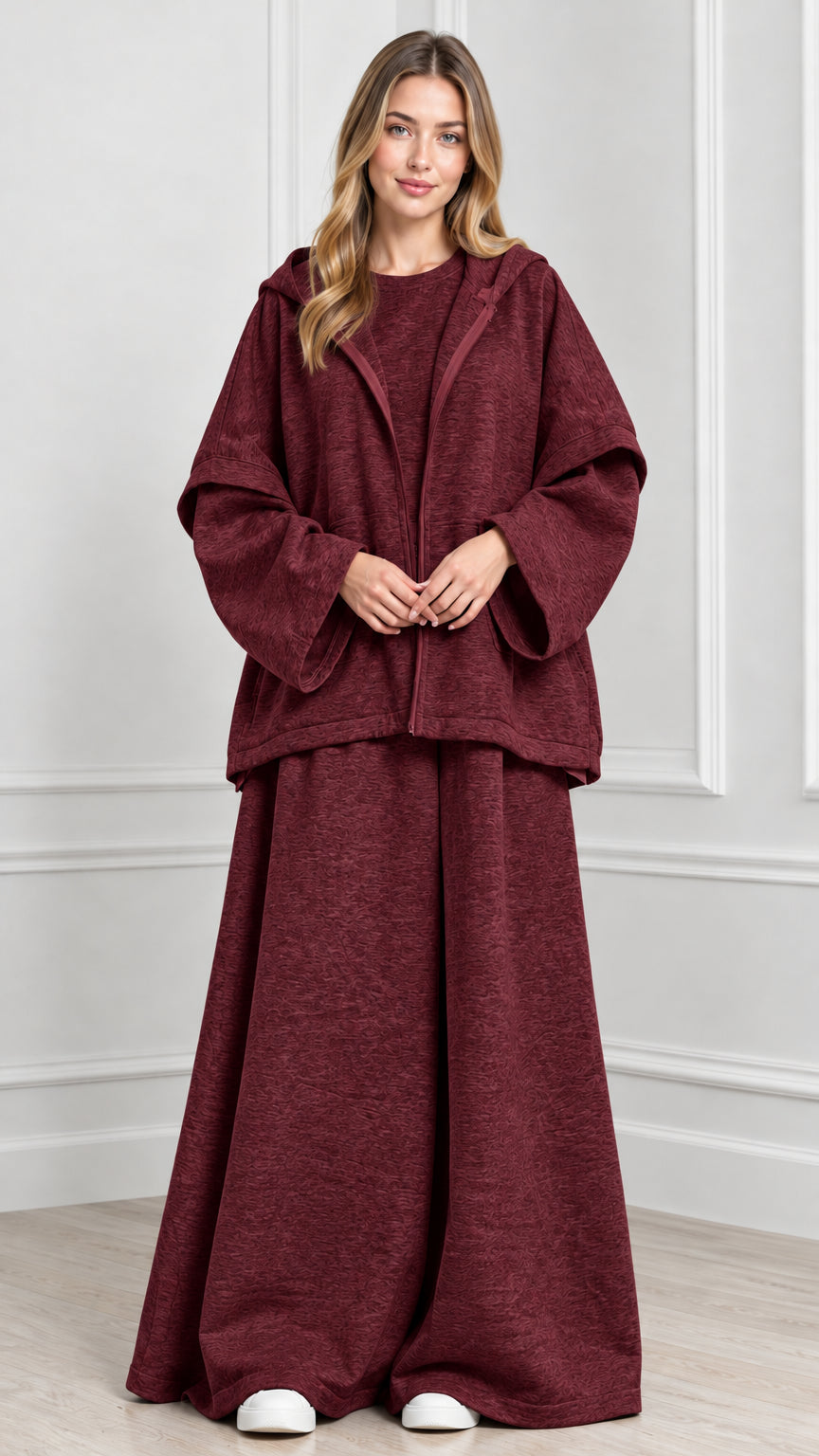 Front view of woman wearing Burgundy hooded cape jacket and wide-leg pants set