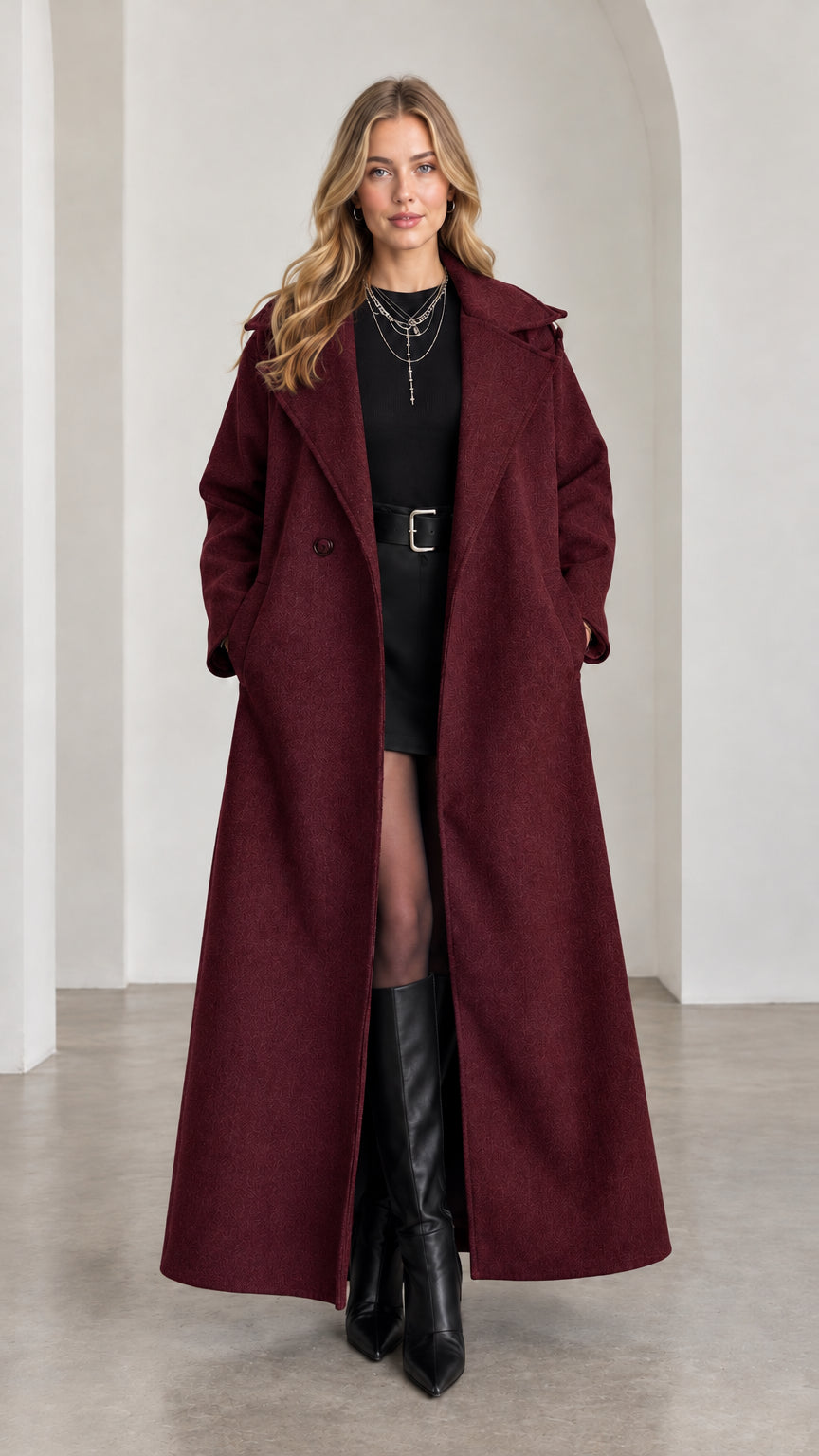 Model wearing rich Burgundy full-length belted overcoat with wide lapels