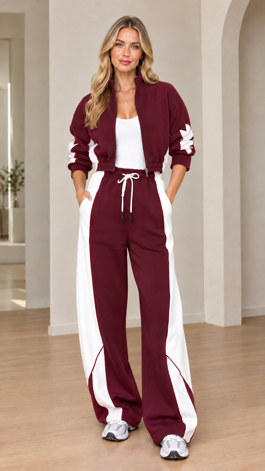 Model wearing burgundy red and white colorblock tracksuit set
