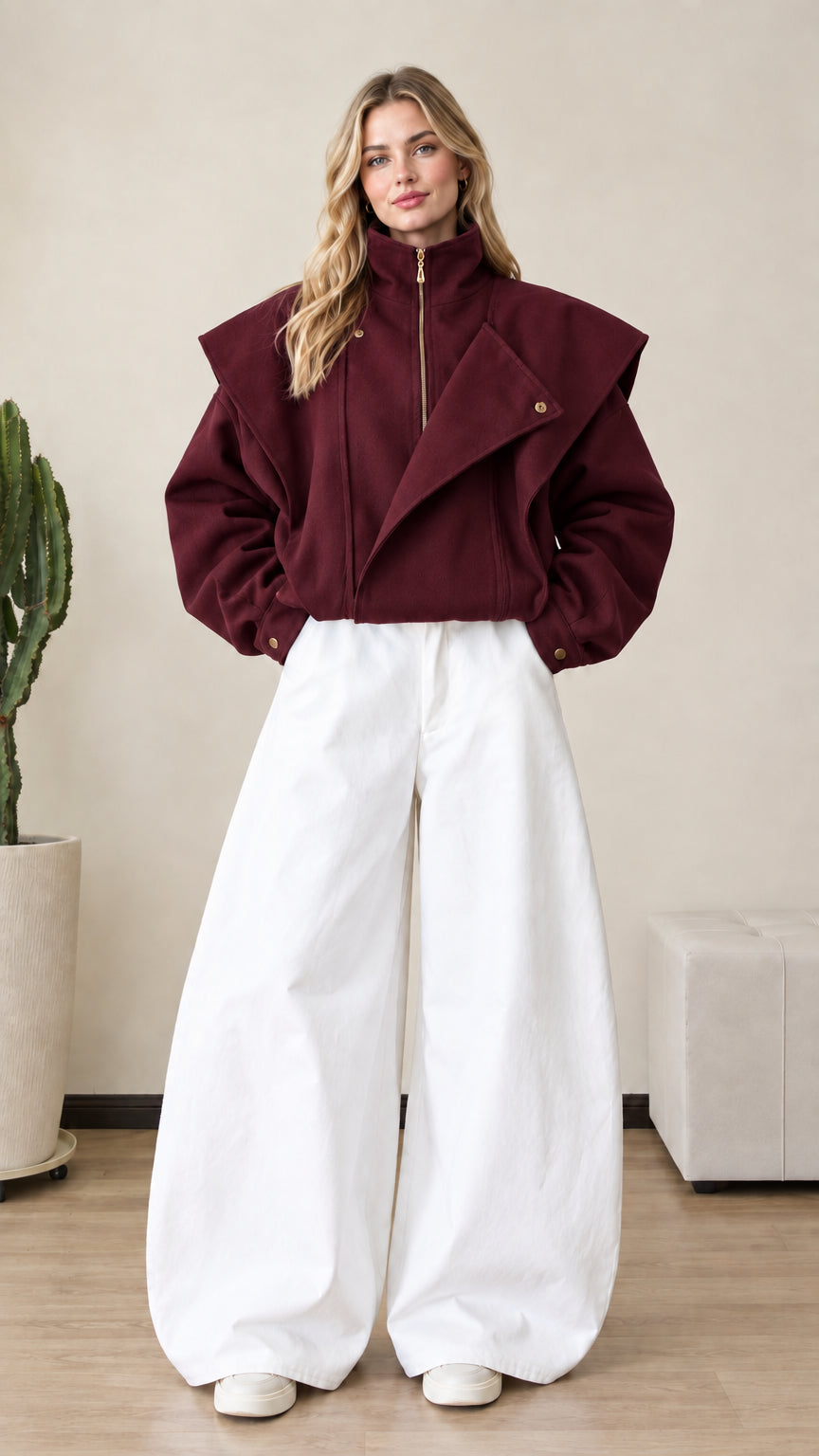 Front view of woman wearing burgundy wine red asymmetrical zip jacket