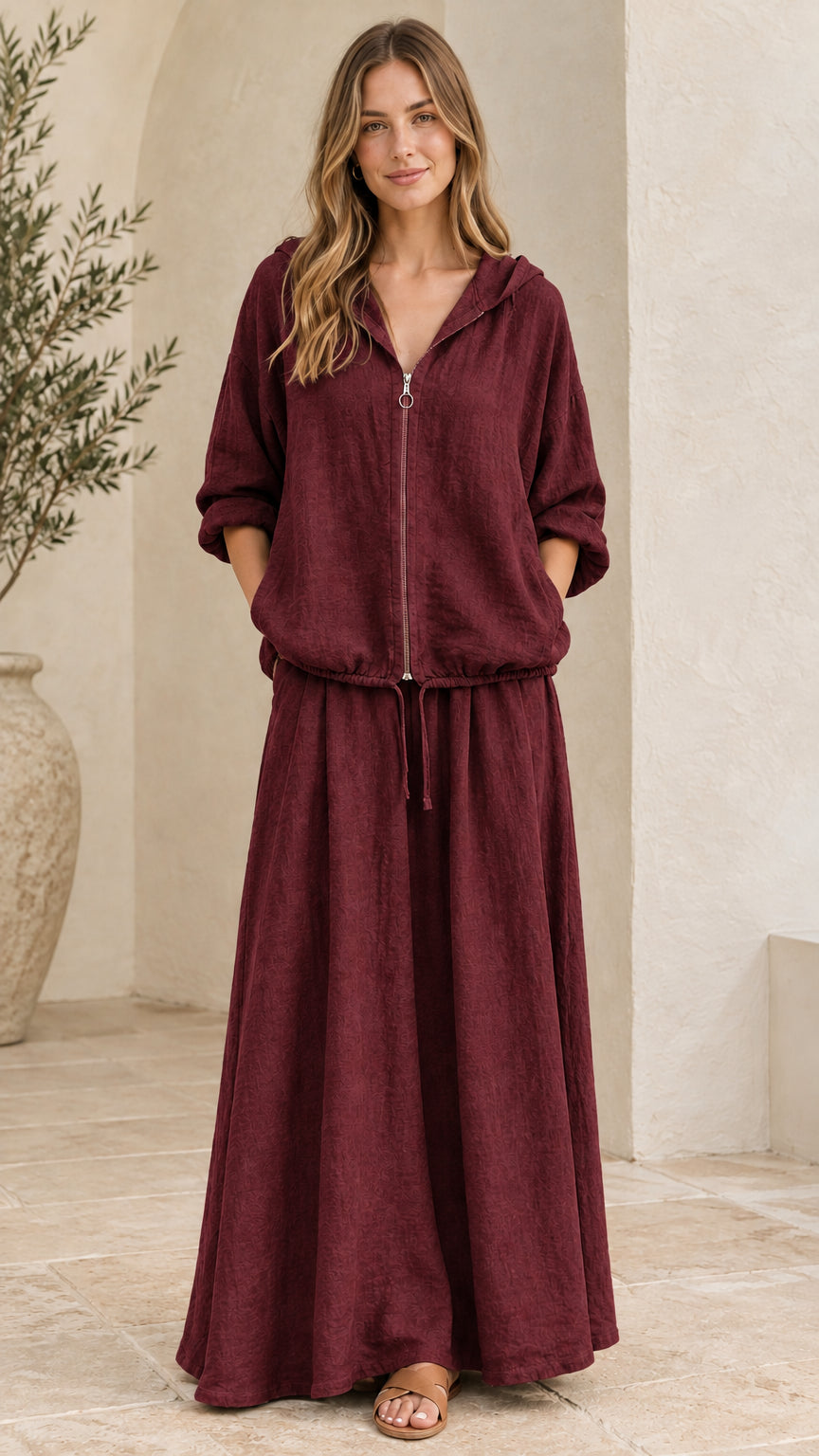 Front view of woman wearing burgundy wine hooded top and maxi skirt set