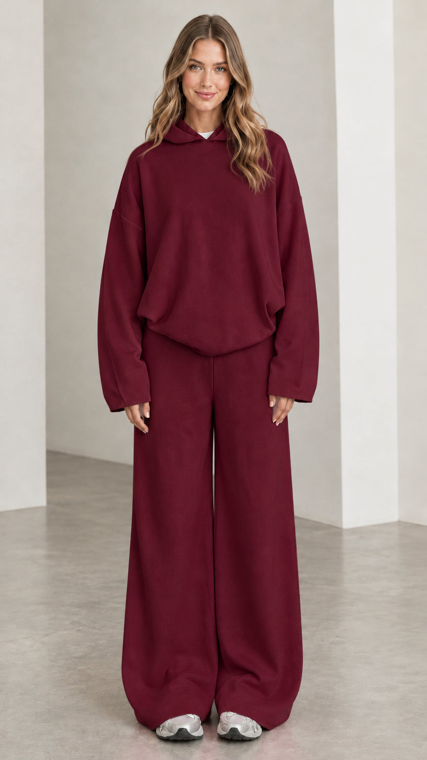 Front view of woman wearing Burgundy hooded sweatshirt and wide leg trousers matching set