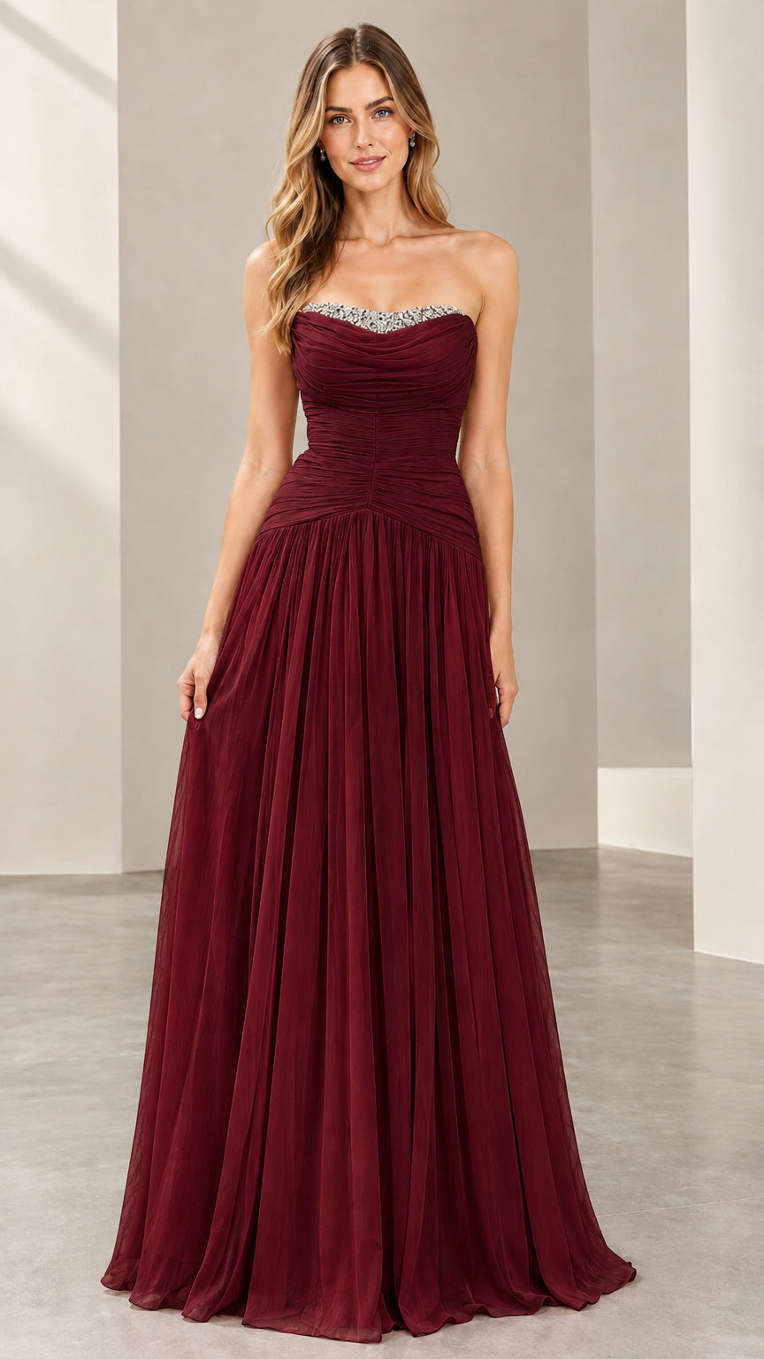 Front view of woman wearing the strapless ruched evening gown in burgundy wine