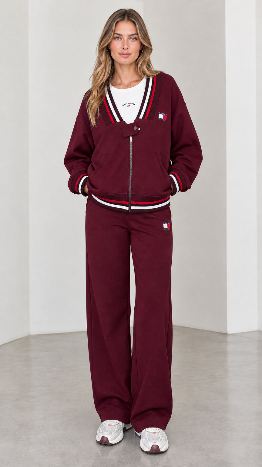 Front view of model wearing burgundy varsity striped tracksuit set