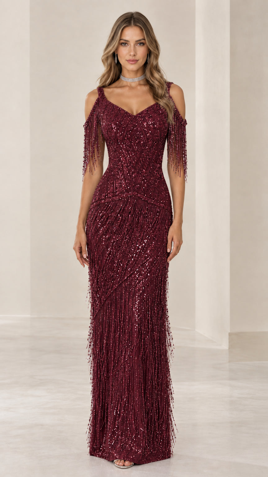 Front view of woman wearing Burgundy sequin cold-shoulder fringe maxi evening gown