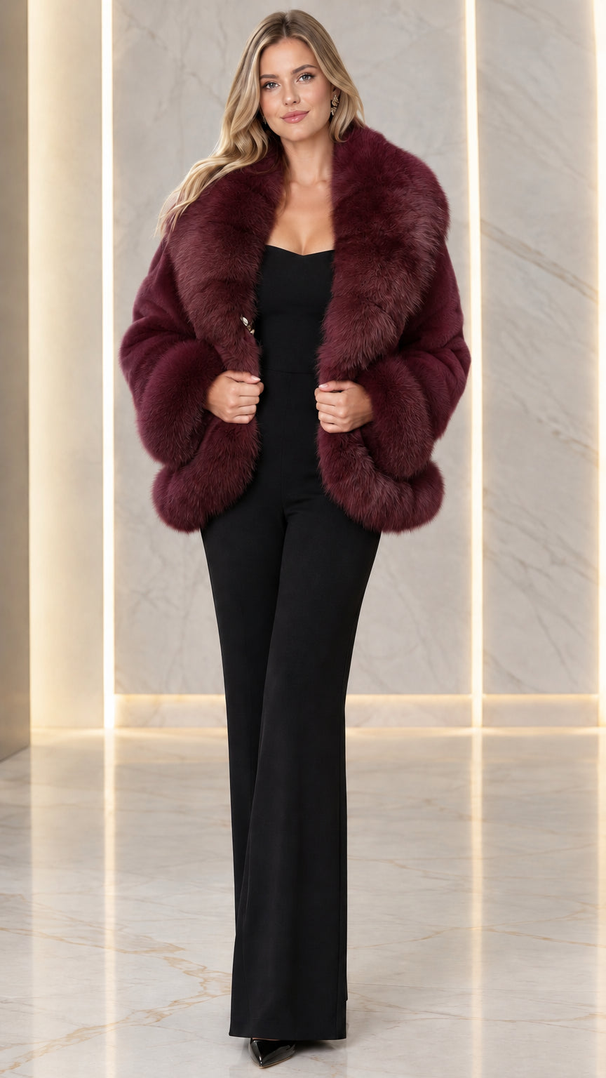 Model wearing burgundy red faux fur winter jacket over black sleeveless jumpsuit