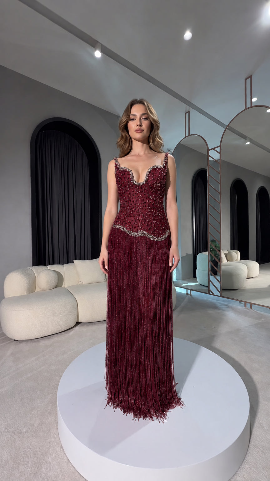 Front view of burgundy red beaded corset fringe evening gown