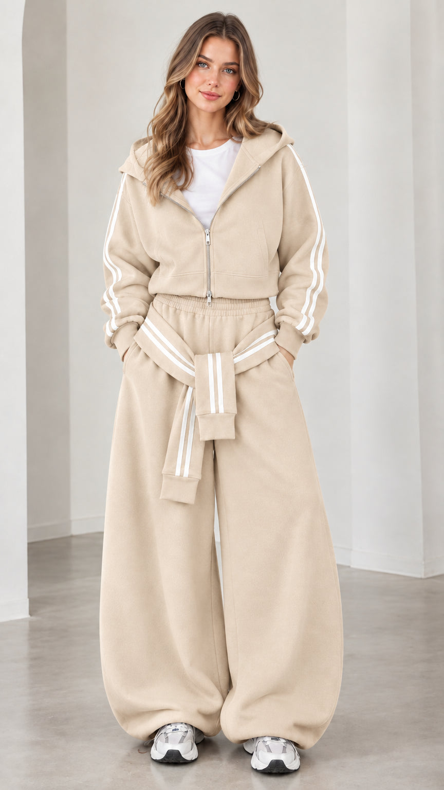 Model wearing beige cropped zip-up hoodie and baggy track pants set