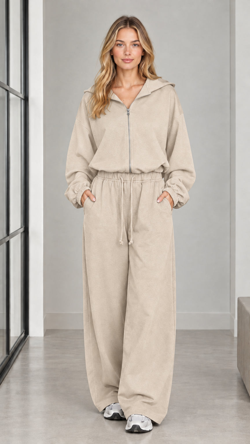 Front full-length view of woman wearing the beige sand hooded wide-leg jumpsuit