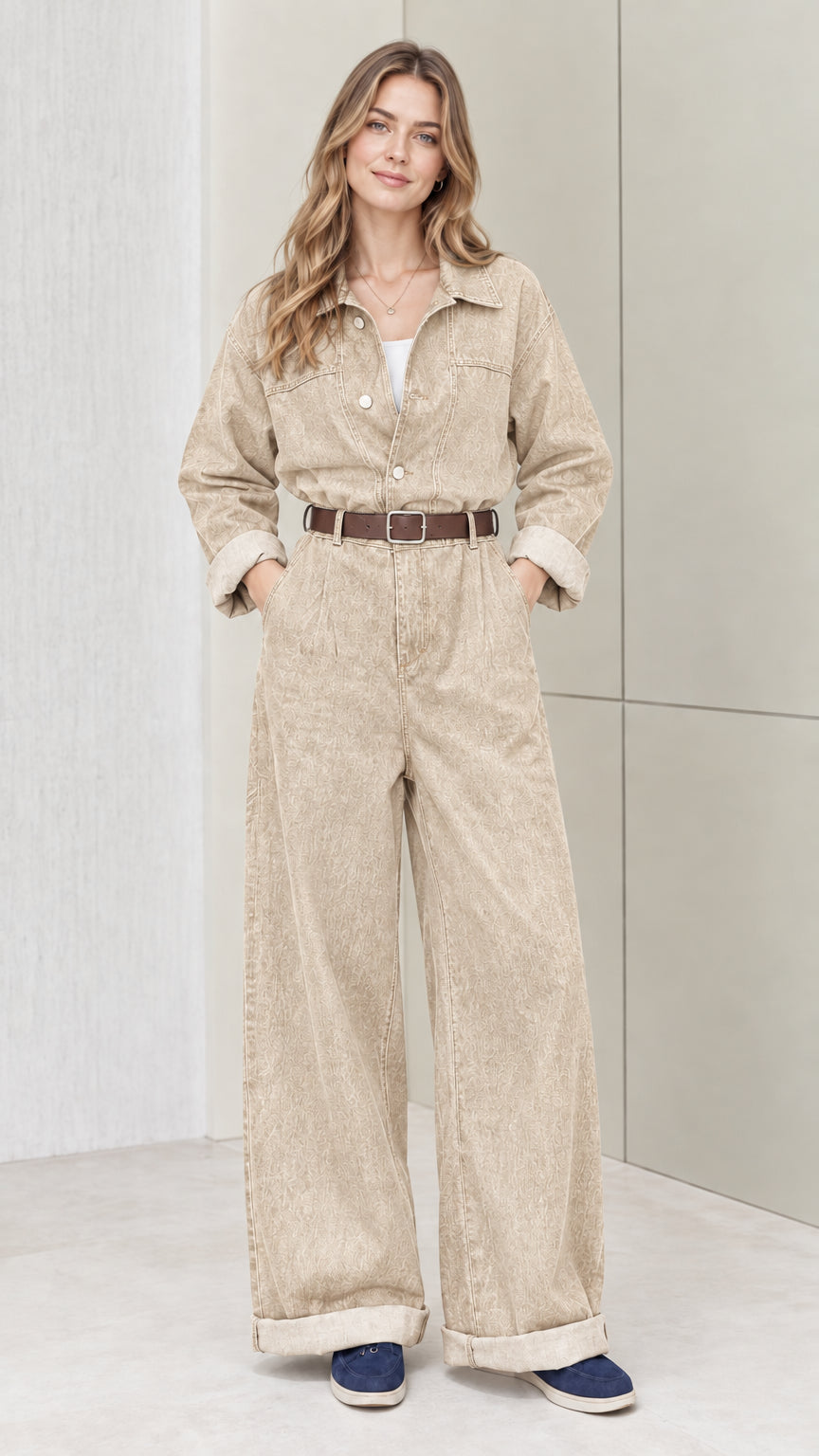 Front view of woman wearing sand beige wide-leg utility jumpsuit with belt