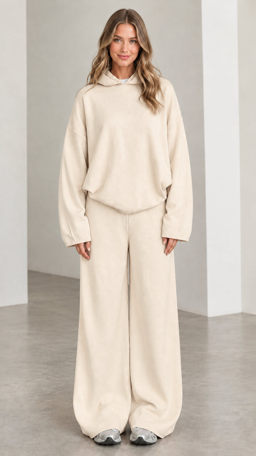 Front view of woman wearing Beige oversized hoodie and wide leg sweatpants lounge set