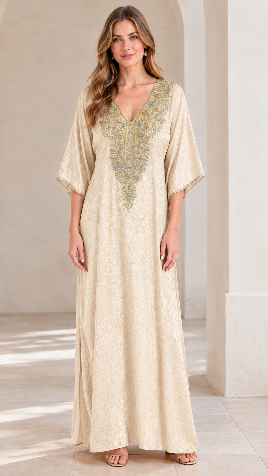 Full front view of woman wearing champagne beige embroidered kaftan maxi dress