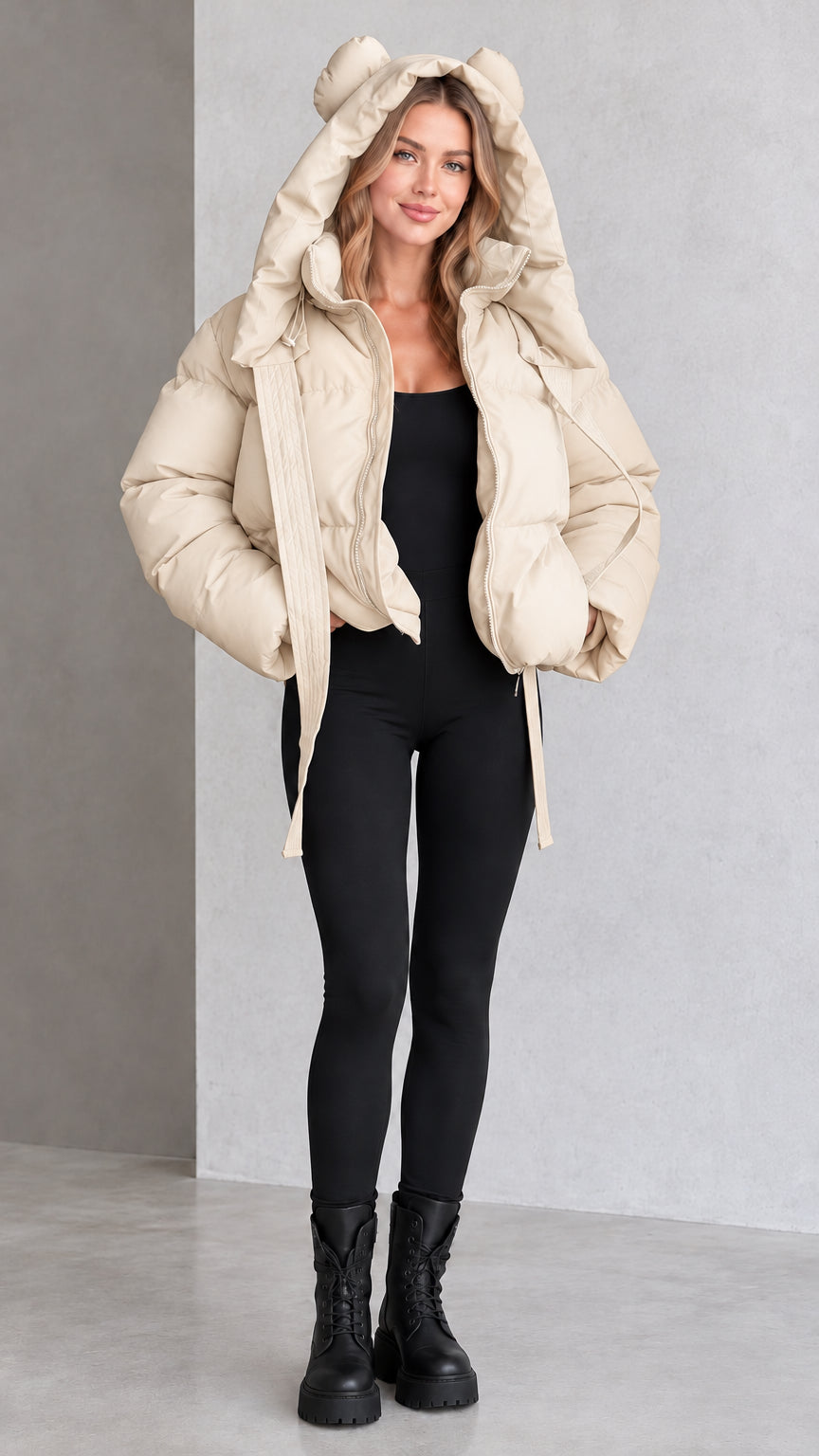 Model wearing beige cream bear ear hooded cropped puffer jacket