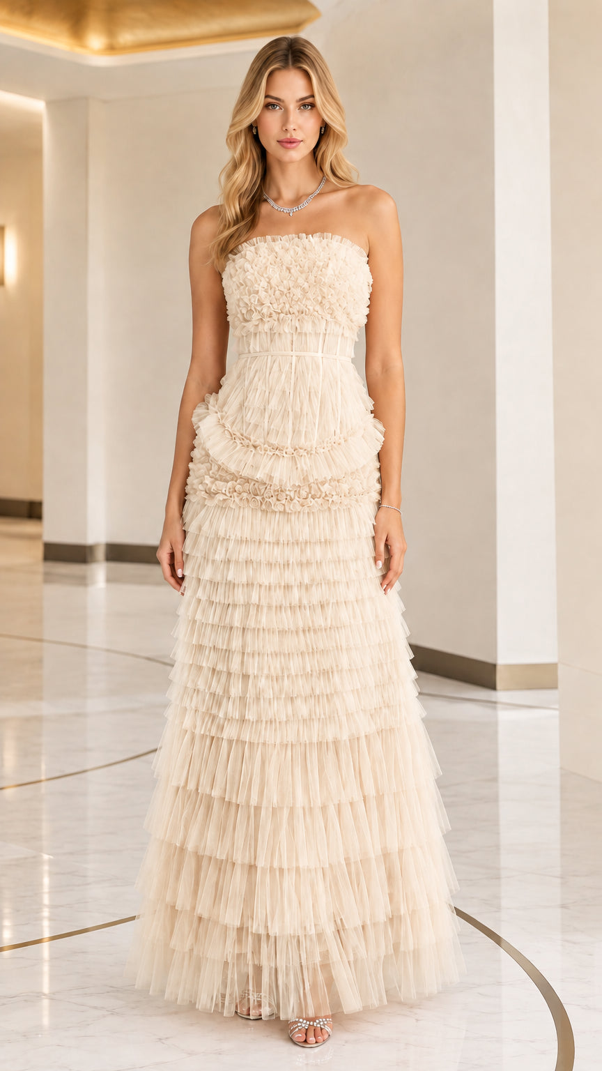 Front full view of woman wearing strapless champagne cream tiered ruffle tulle evening gown
