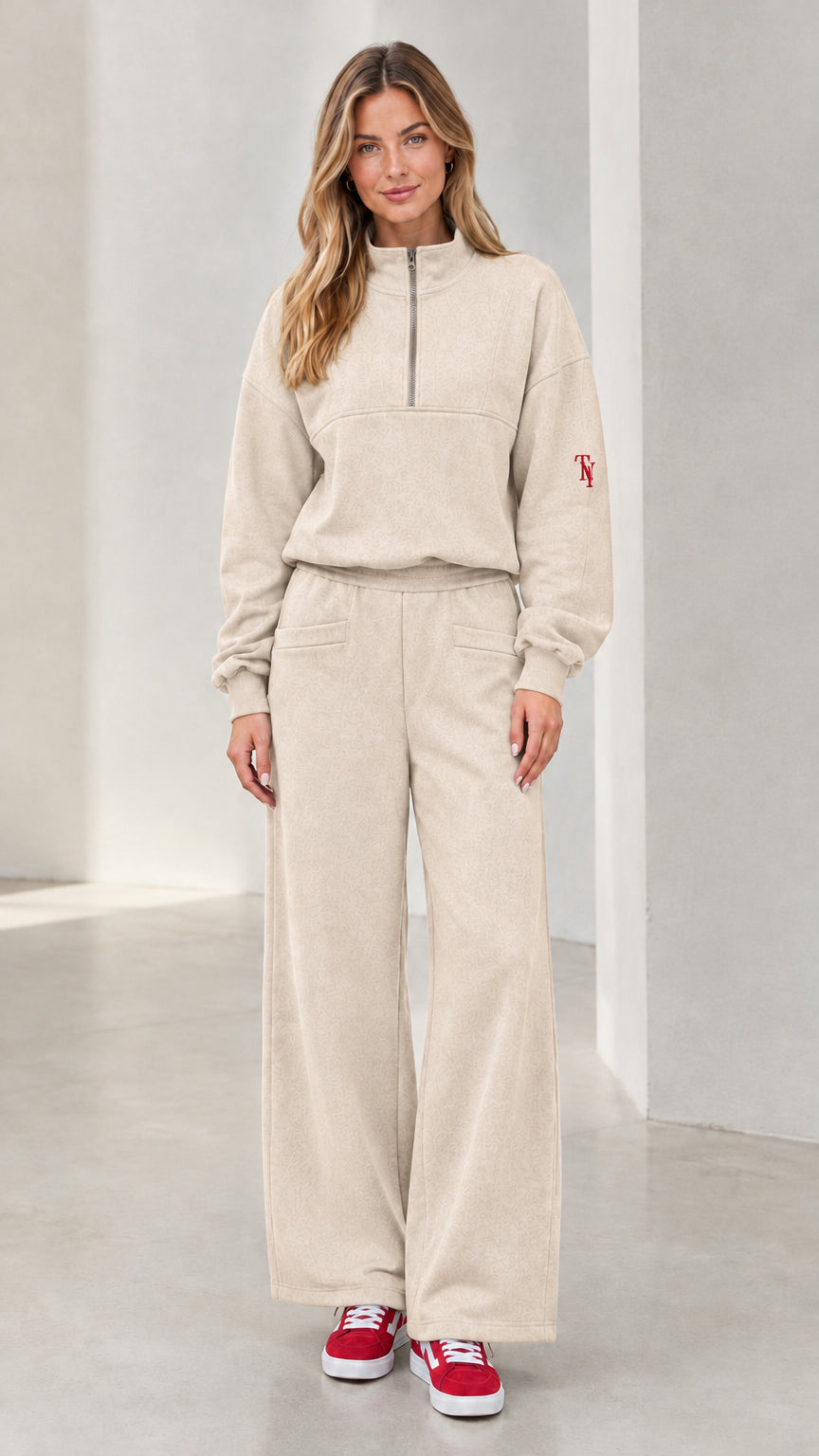 Front view of woman wearing beige half-zip pullover and wide-leg lounge set