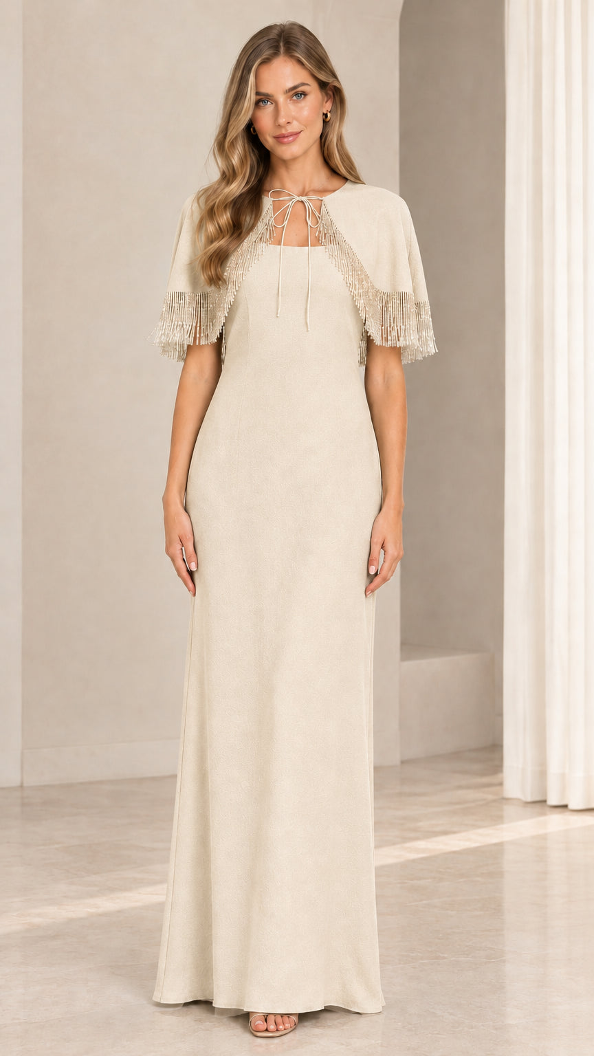 Model wearing champagne beige floor-length gown with beaded fringe cape