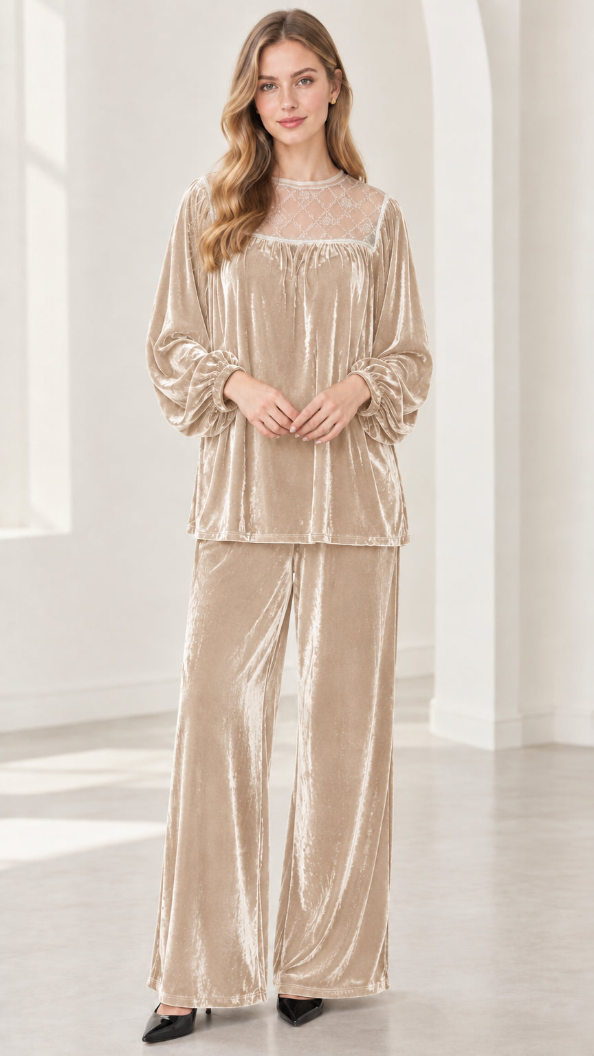 Full-length view of model wearing champagne gold velvet two-piece pant set